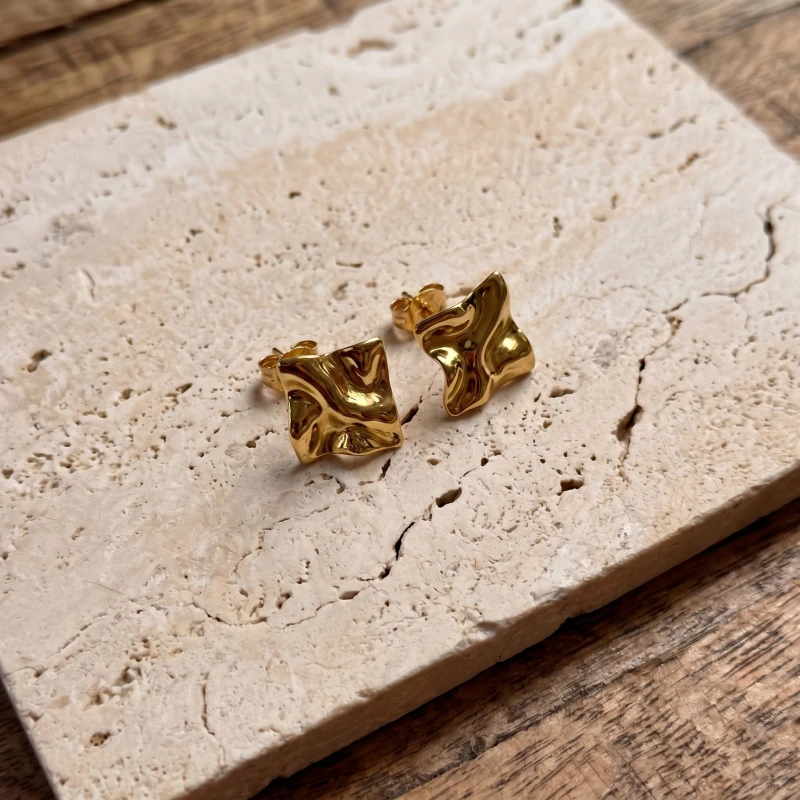 Gold_stud_earrings_with_a_202606241112.jpeg